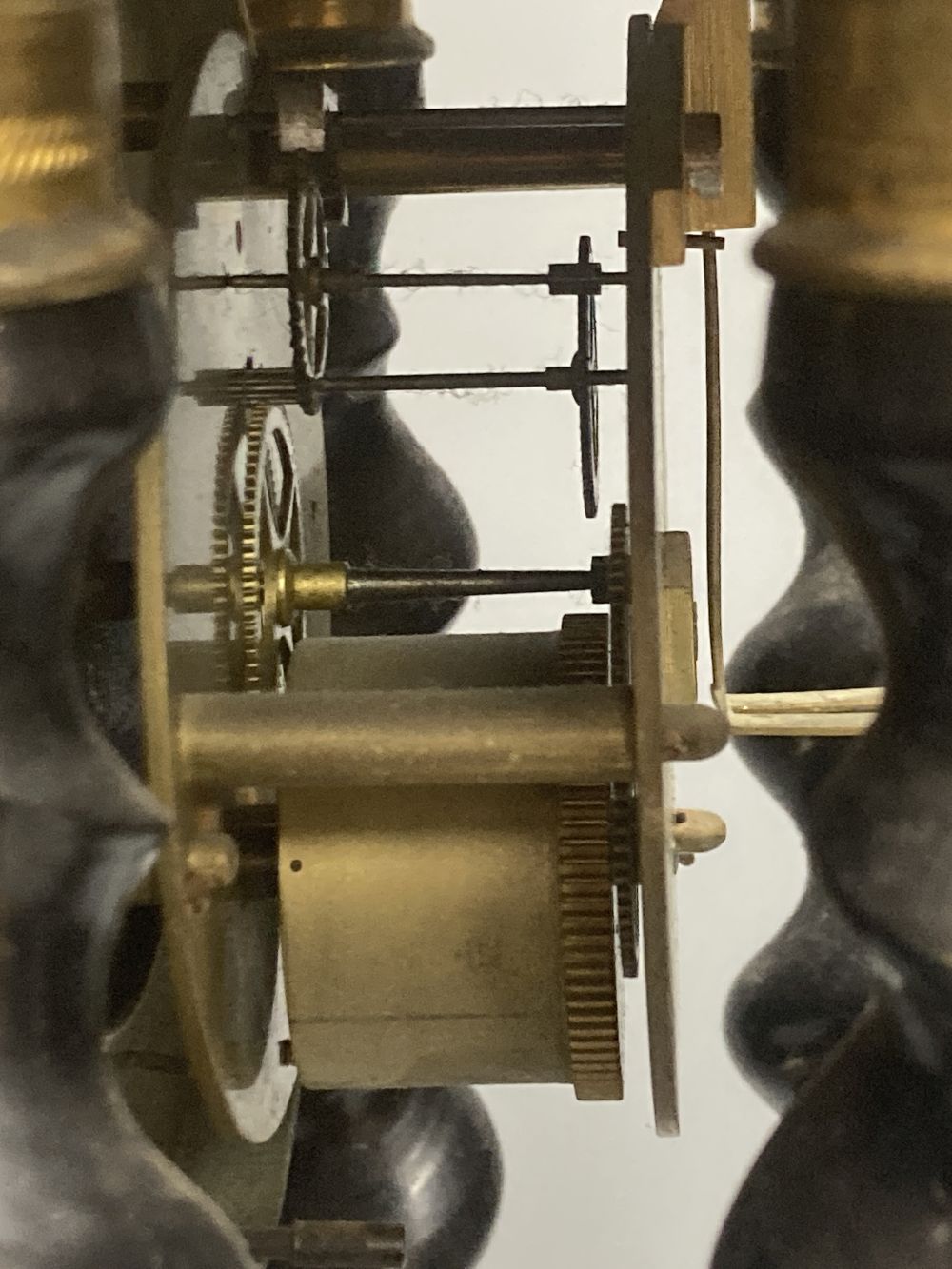 A 19th century French portico ebonised mantel clock, enamelled dial and timepiece movement, gridiron pendulum, 44cm high